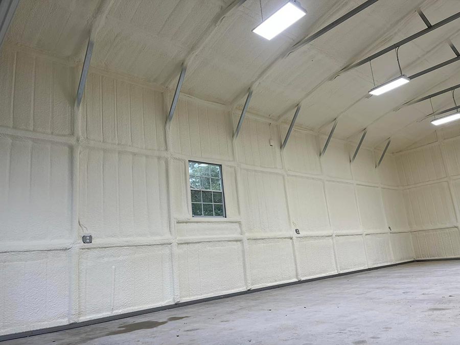 Closed-cell spray foam insulation on metal building roof trusses and wall panels in Montgomery, TX