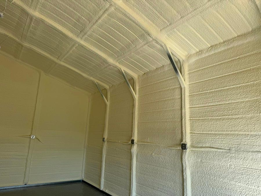 Closed-cell spray foam insulation on garage door wall and gambrel roof in a Liberty, TX barndominium